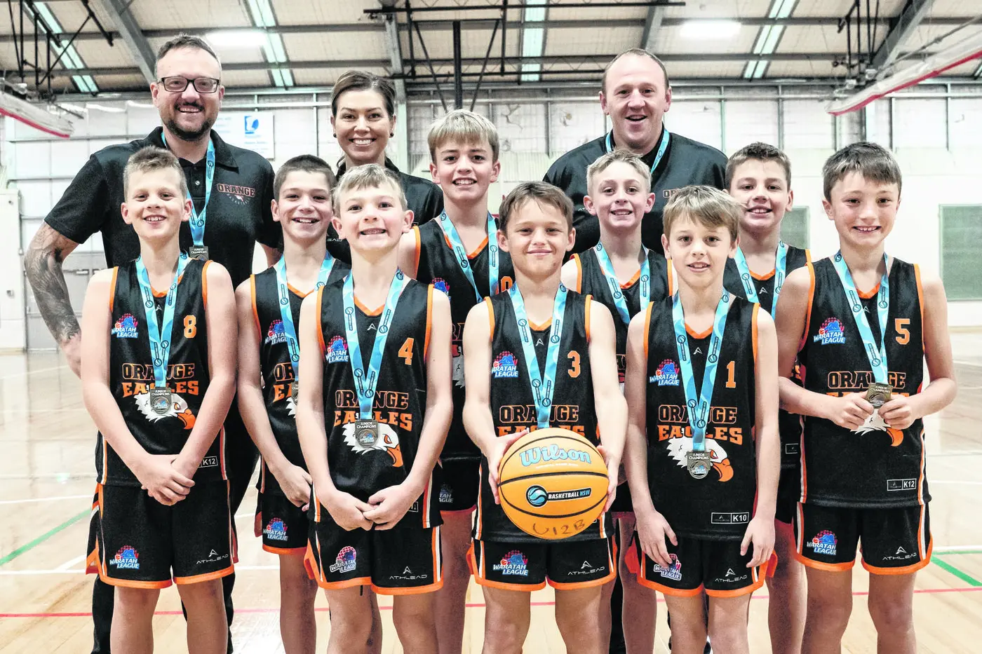 The victorious Orange Eagles under 12s boys division one side for 2025. Back, from left: Mitch Brakenridge (coach), Tam Keegan (manager), Paul Ringland (coach). Middle, from left, Dylan Brakenridge, Artie Keegan, Jax Murphy, Sawyer Oldrey Mills, Henry Sullivan. Front, from left,  Ashton Threlfall, Lachlan Bailey, Hudson Mcalpine, Barnaby Luelf. Photo: Supplied. 
