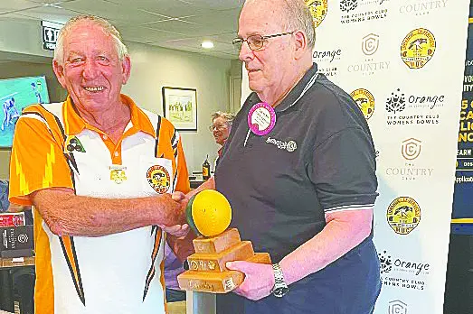 Country Club Vice President, Peter Brooking accepting the trophy of City V\\u2019s Country Clubs Charity Day from Orange Lions Club President Graeme Eggleston.