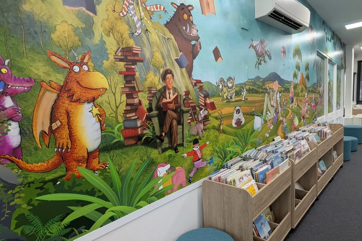 Bowen\\'s stunning new library mural depicts renditions of popular children\\u2019s book characters upon a background of Orange landmarks.