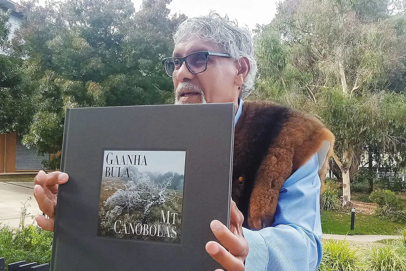 Uncle Neil Ingram pictured with Allan Starr\\u2019s photo book.