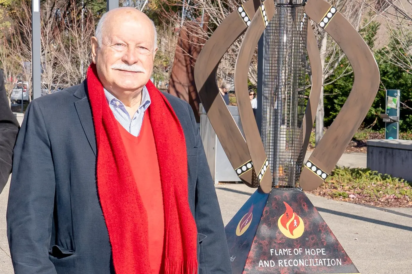 Mr Chris Gryllis, pictured with the Flame of Hope and Reconciliation, has been awarded the Medal of the Order of Australia (OAM) in the General Division. Photo: Orange City Life/file