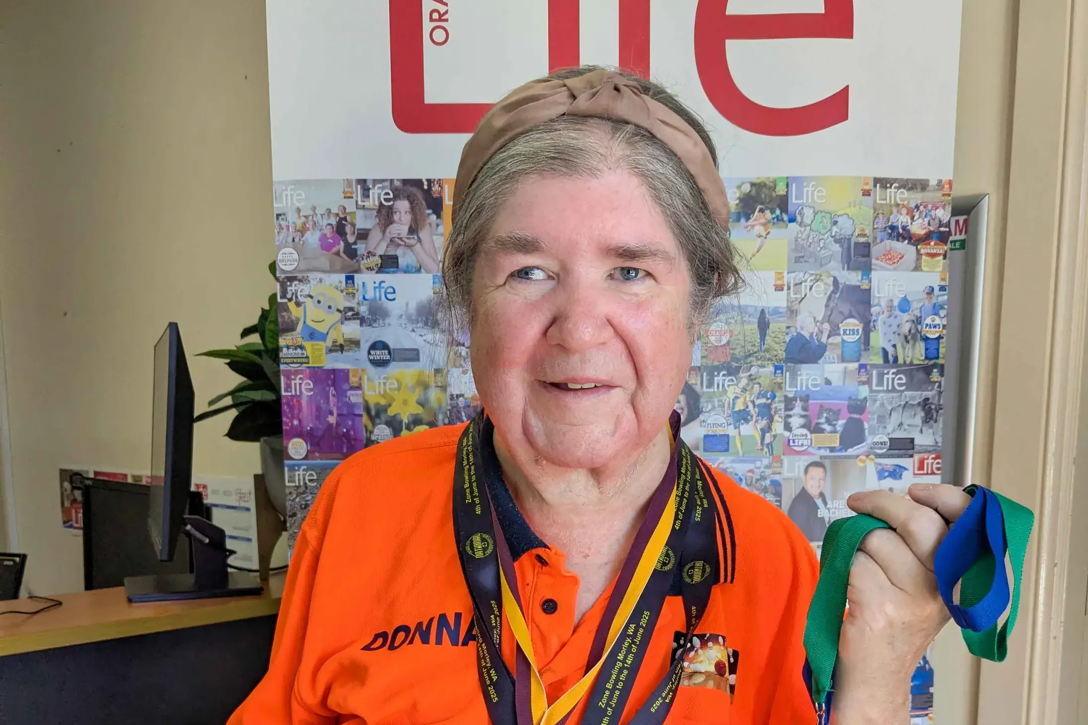 <p>Local star vision-impaired tenpin bowler, Donna Holland, shows off her recent haul of medals.</p>\\n