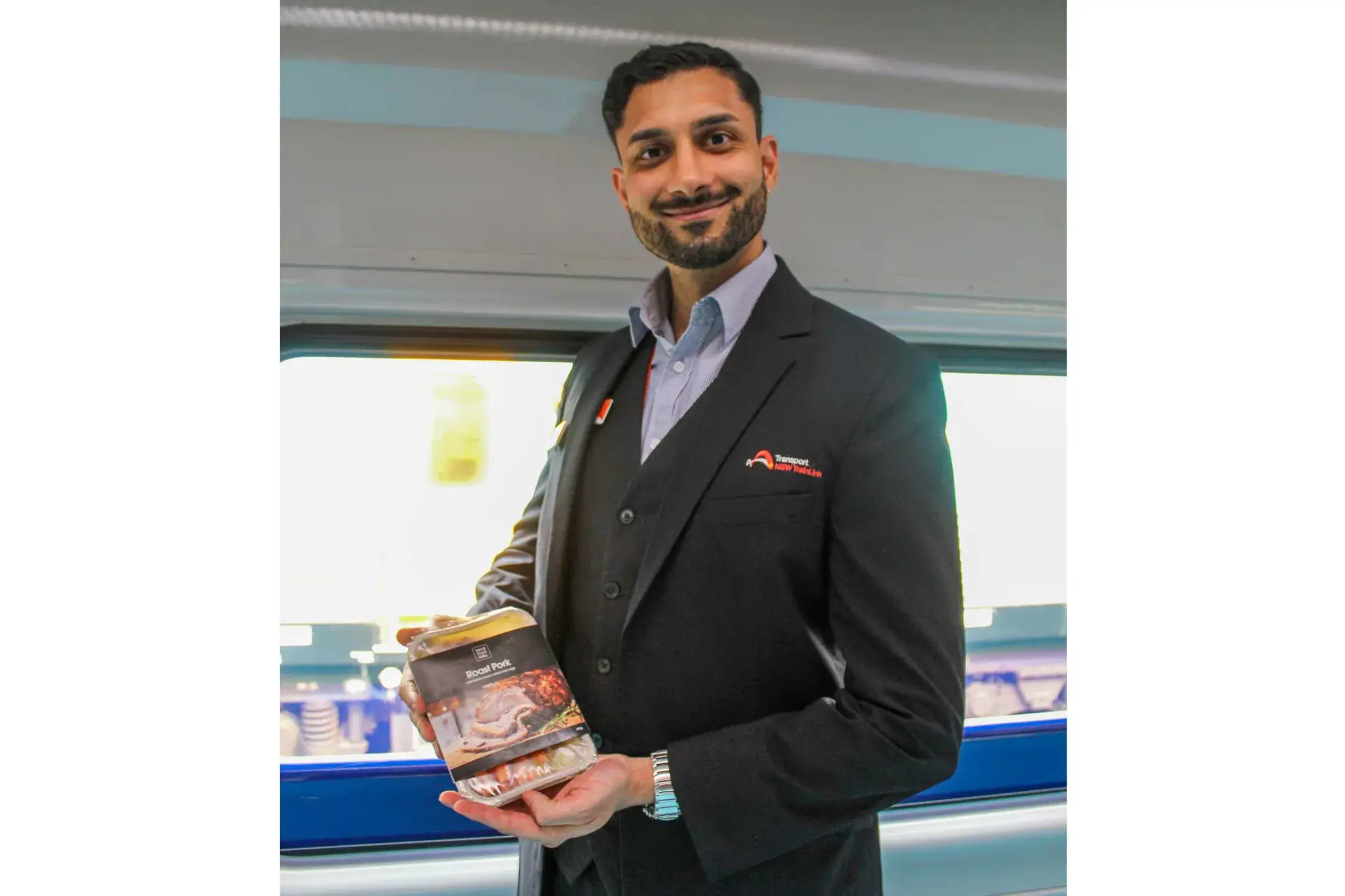 <p>Crew member Jonathon Rodricks with items from NSW TrainLink\\'s buffet menu. Photo: Supplied</p>\\n