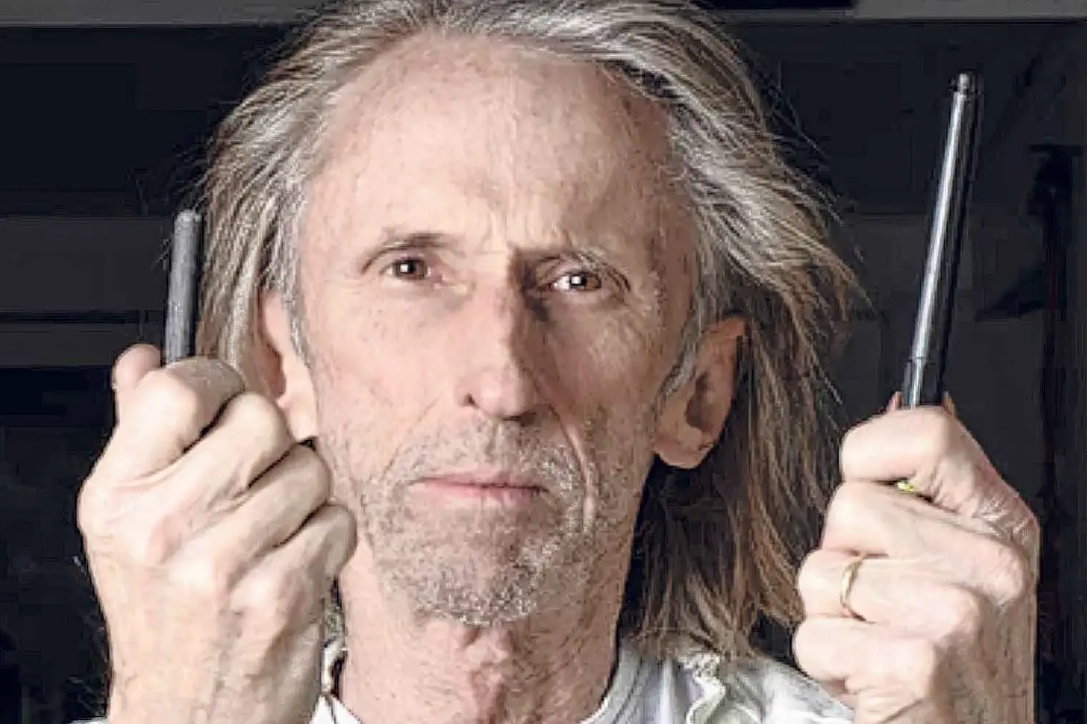 <p>Reg Mombassa with the tools of his art trade. Photo: Supplied.</p>\\n