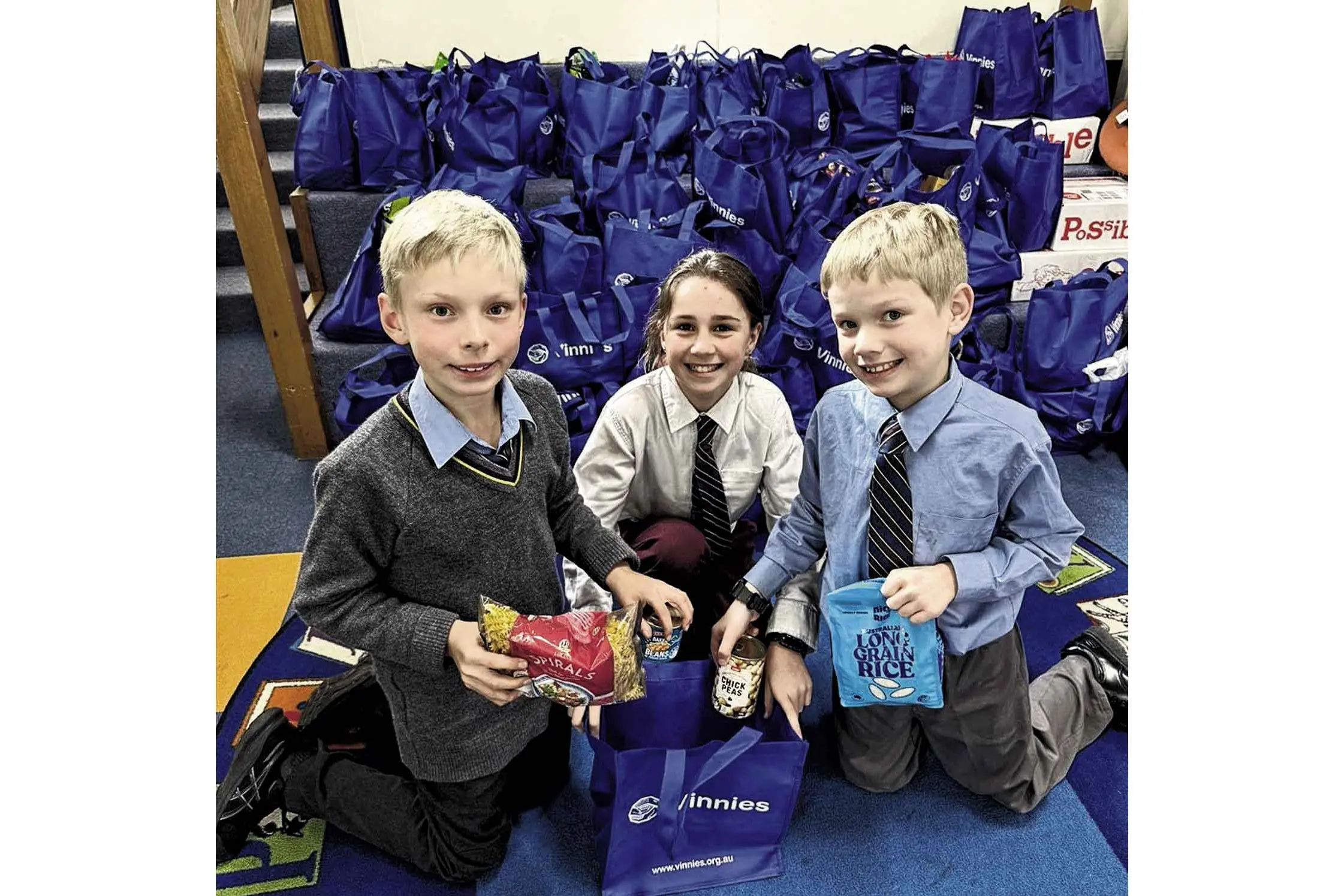 <p>Lincoln Maley, Annabelle Groves, Graham Jones, with food items collected for Vinnies Winter Appeal.</p>\\n