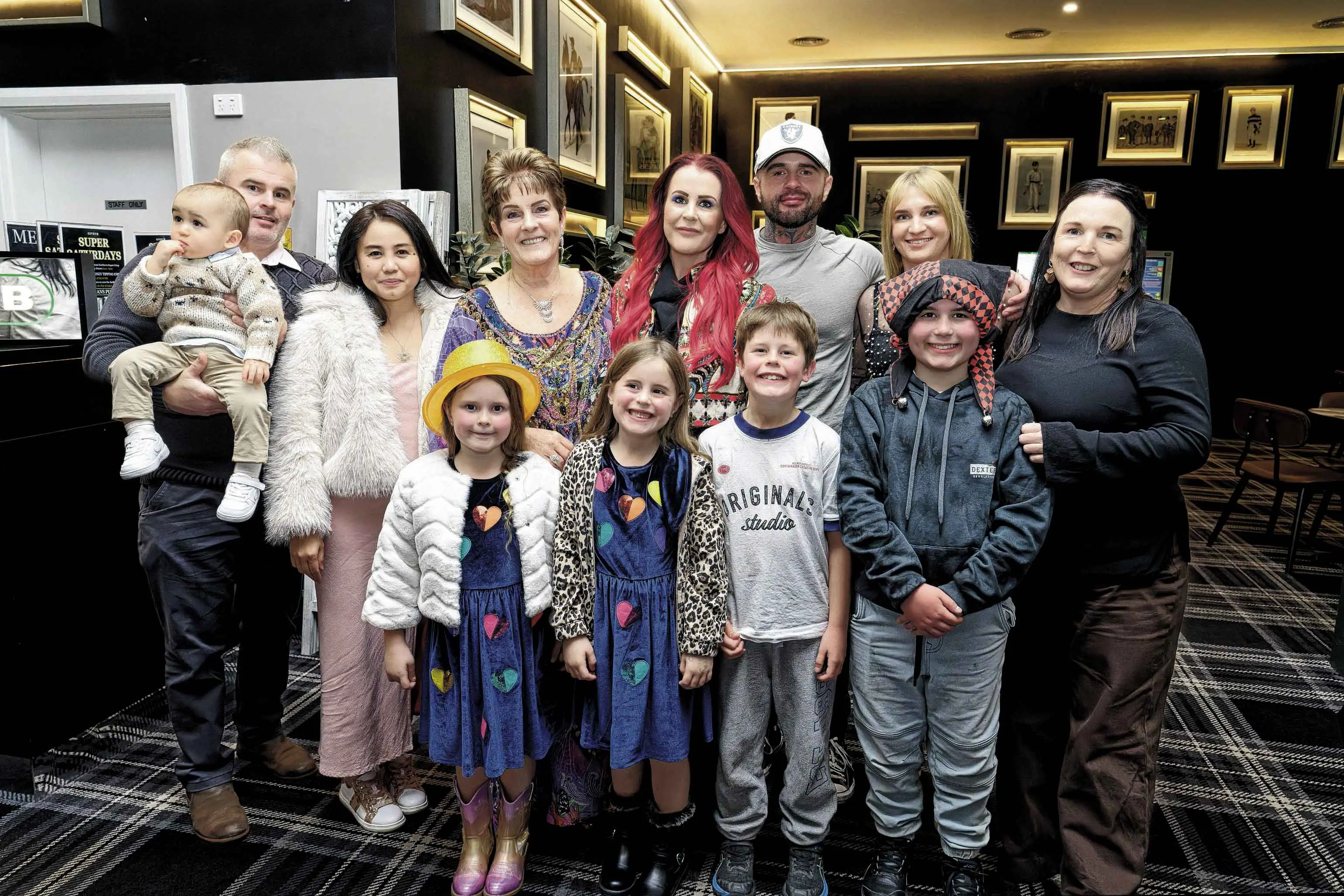 <p>Beth Baker (back, fourth from left) with her family. Photo: Orange City Life. </p>\\n