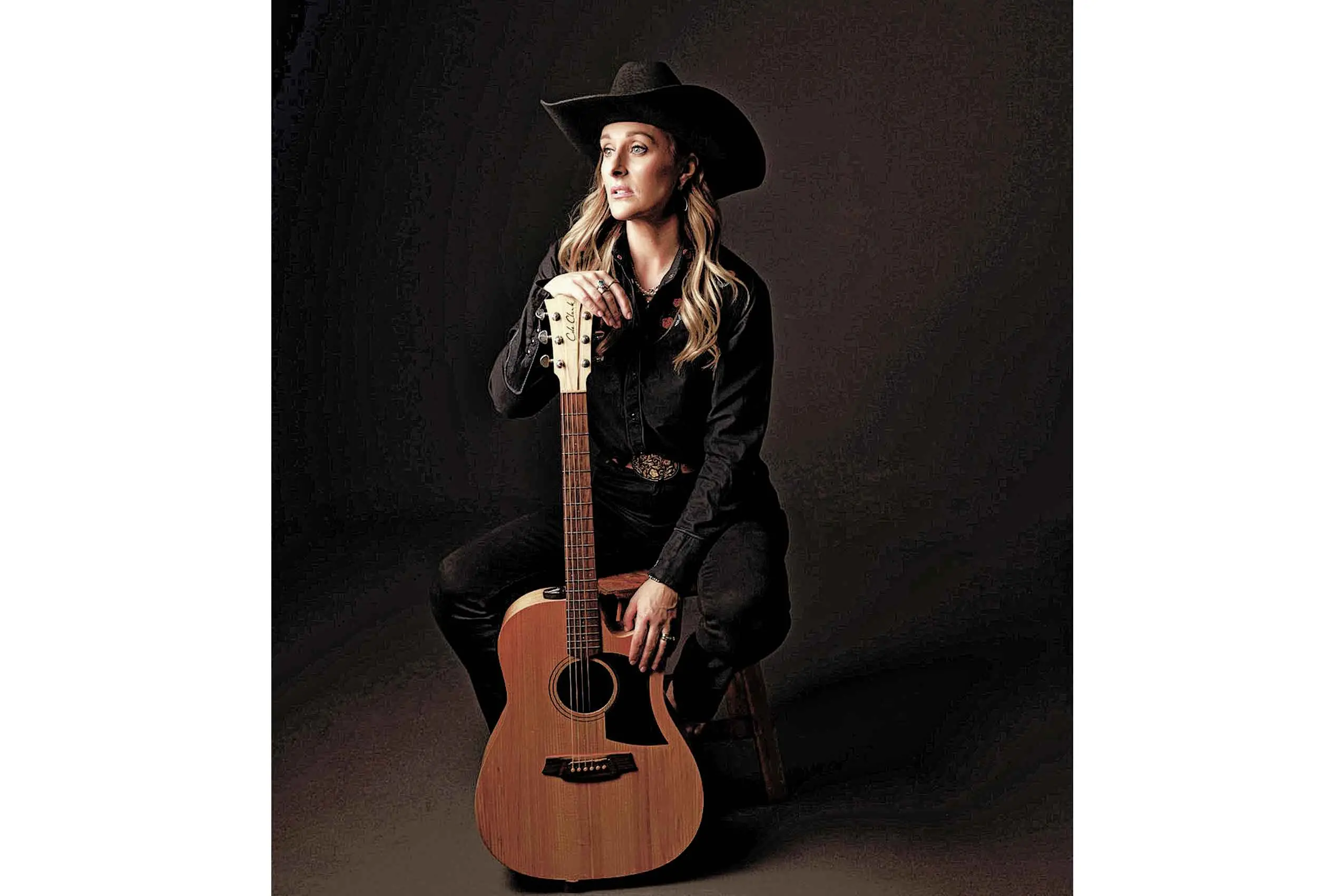 <p>Megan Woods with one of her workhorse guitars. Photo: Supplied.</p>\\n